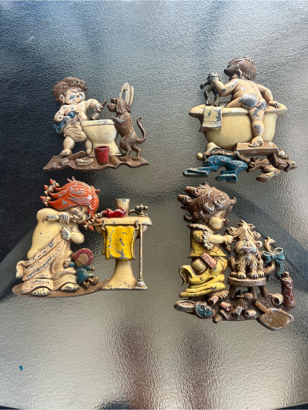 Set of Four Cast Metal Wall Sculptures in Yellow, Cream, Blue and Brown